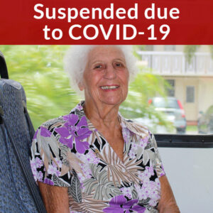 Suspended due to COVID-19, elderly woman in a bus smiling at the camera