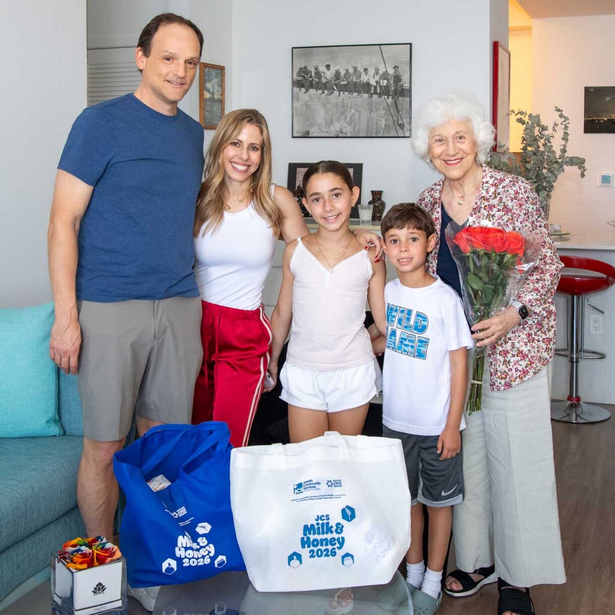 family visits a senior citizen during the Milk & Honey event