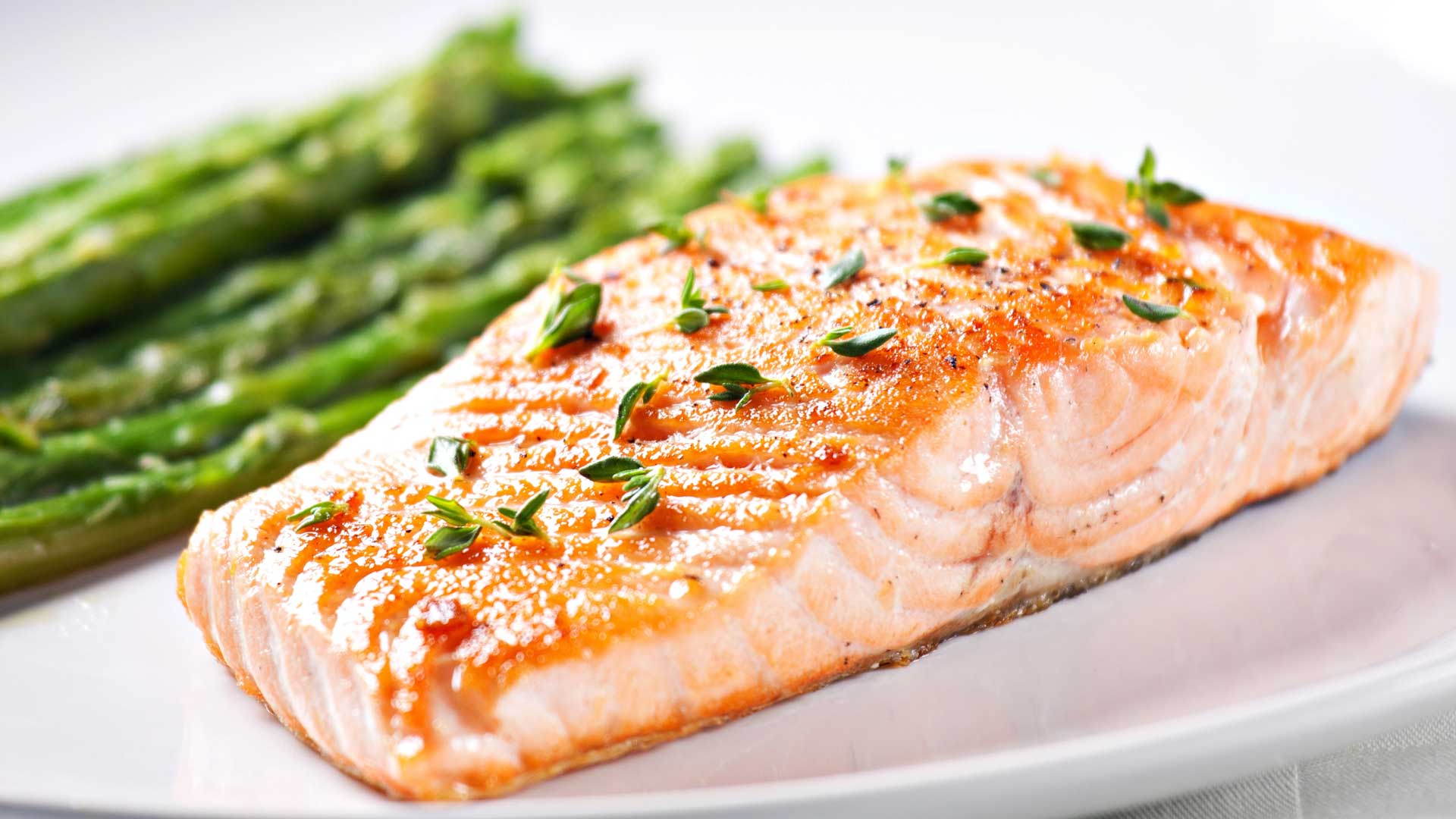 cooked salmon on dish with roasted asparagus