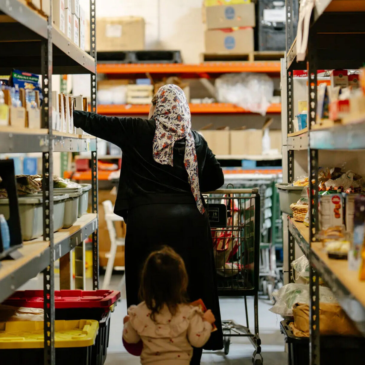 Aviva W. walking down the aisles at the Jewish Community Services Kosher Food Bank in North Miami, Fla., last month. Credit Martina Tuaty for The New York Times
