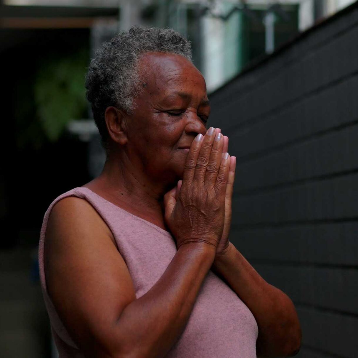 African American elderly woman outdoors standing in narrow passa